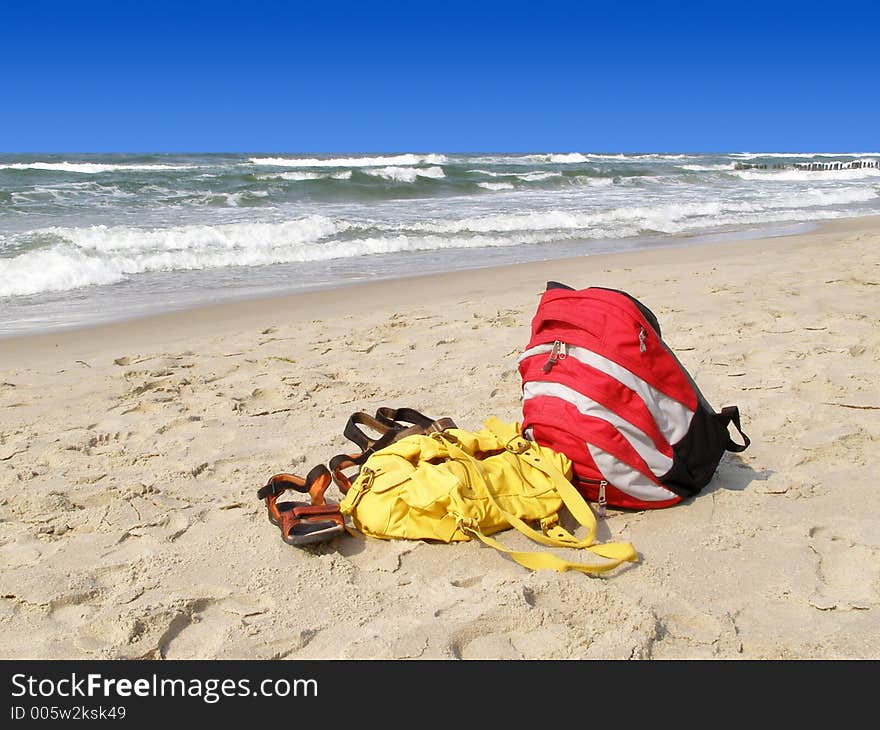 Sandals and rucksack alone on the beach. Sandals and rucksack alone on the beach