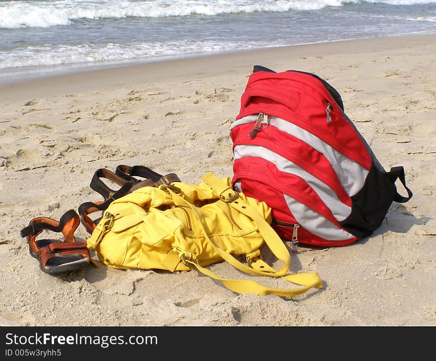 Sandals and rucksack alone on the beach. Sandals and rucksack alone on the beach