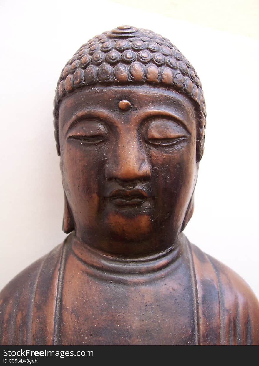 Close-up of Buddha ornament on a white background