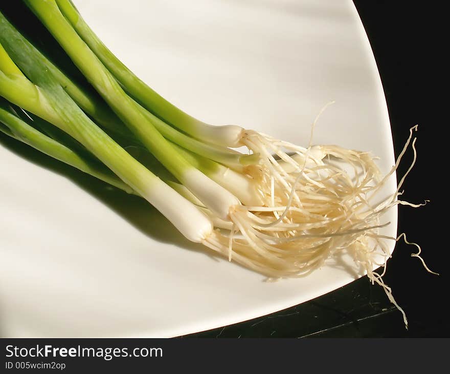 Young onions on a plate. Young onions on a plate