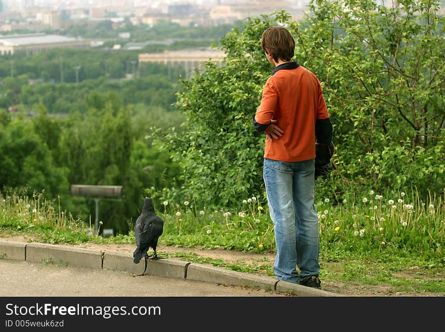 The trainer with a black raven on a background of city. The trainer with a black raven on a background of city