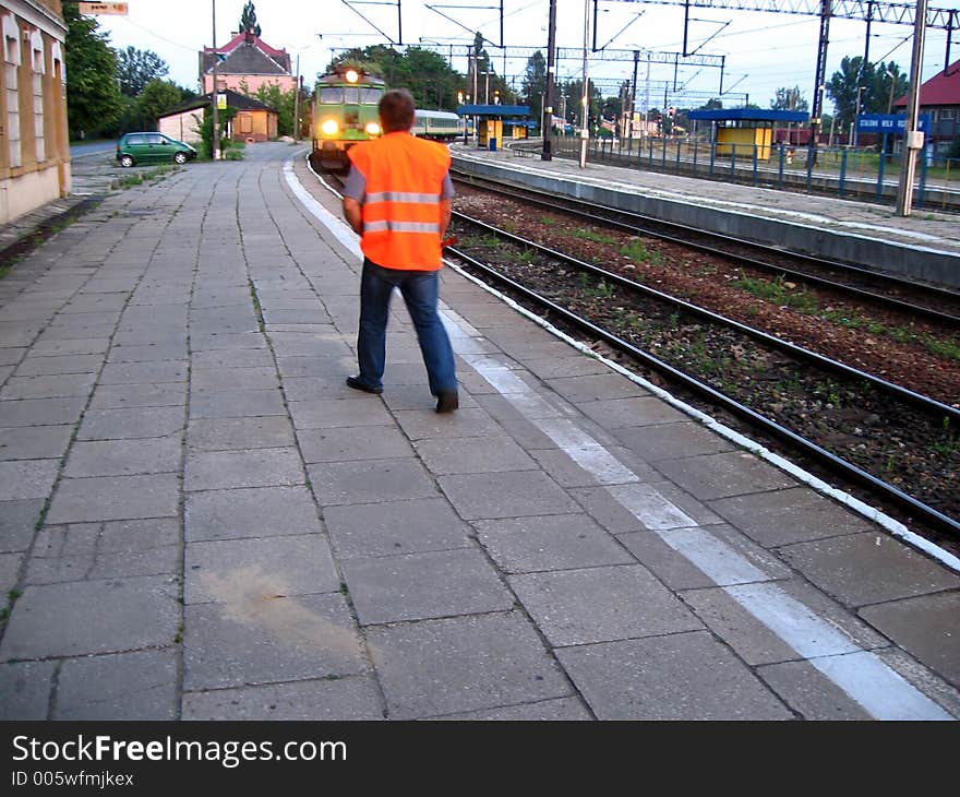 Train riding to railroad station and walking railwayman