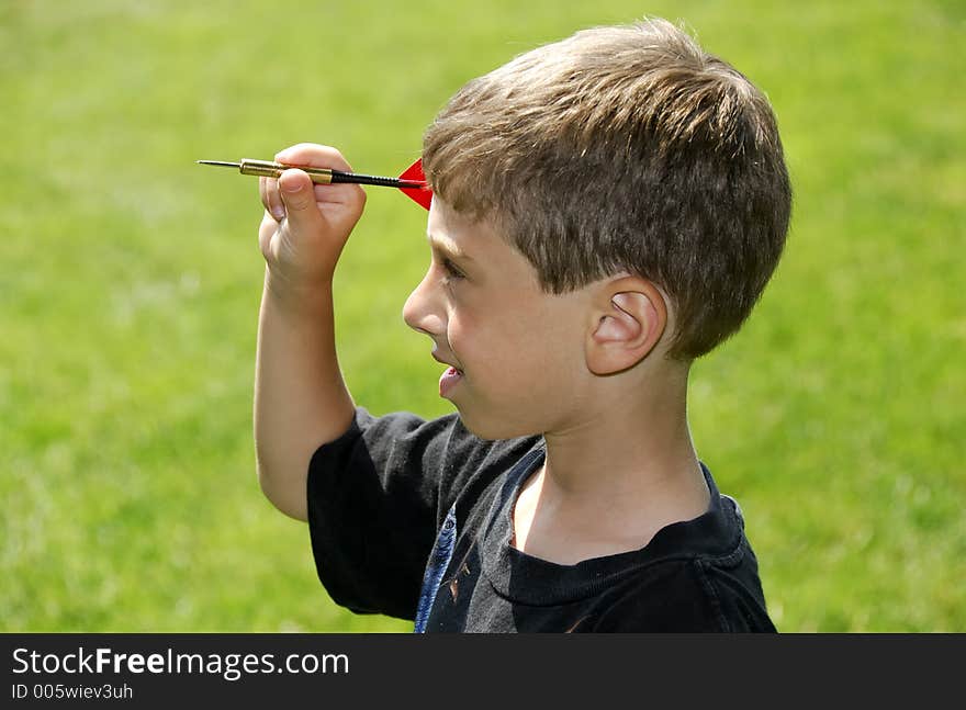 Child Holding a Dart. Child Holding a Dart