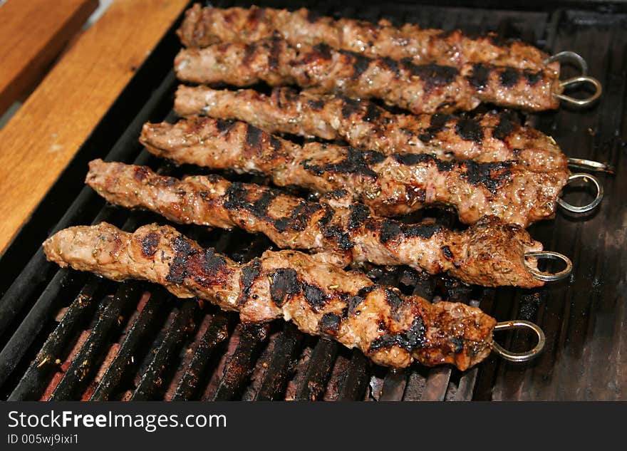 Meat being barbecued on a gas grill. Meat being barbecued on a gas grill