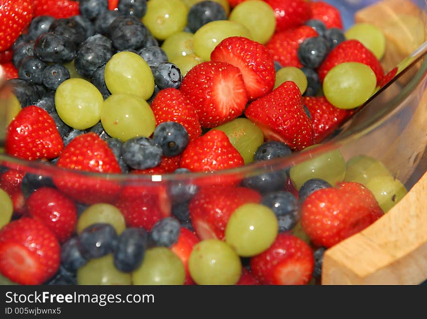 A dish of fresh berries, strawberries, blueberries, grapes. A dish of fresh berries, strawberries, blueberries, grapes