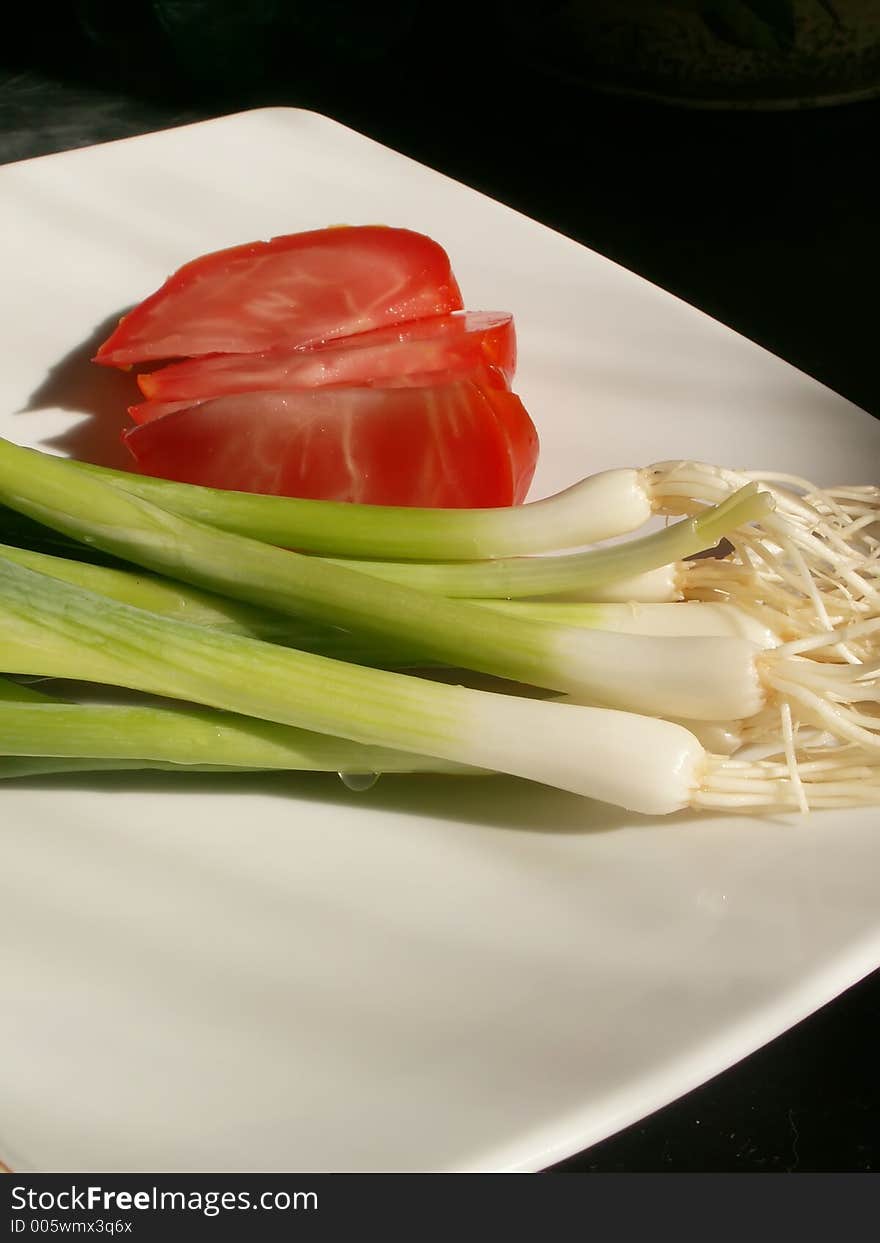 Tomato and chive on a plate