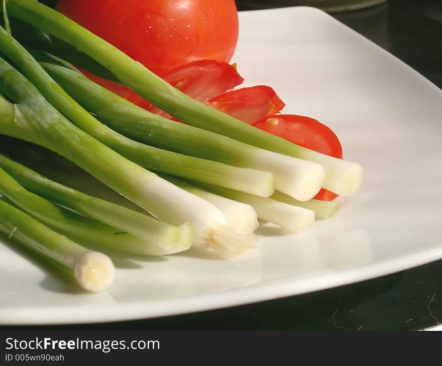 Chive and tomatos on a plate. Chive and tomatos on a plate