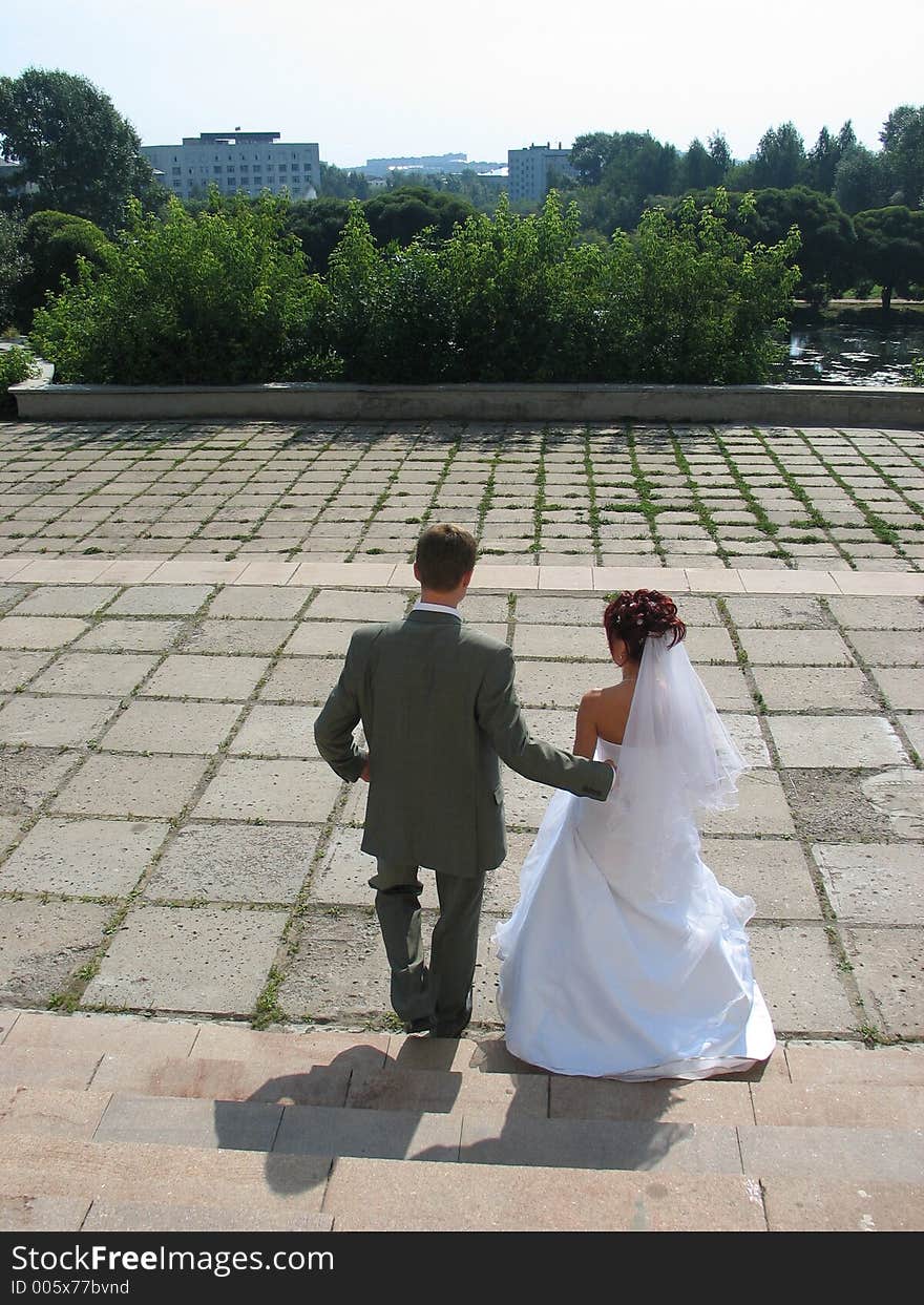 Newly wedded are walking down the street