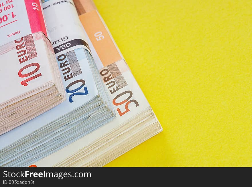 Different money batches on yellow background. Different money batches on yellow background