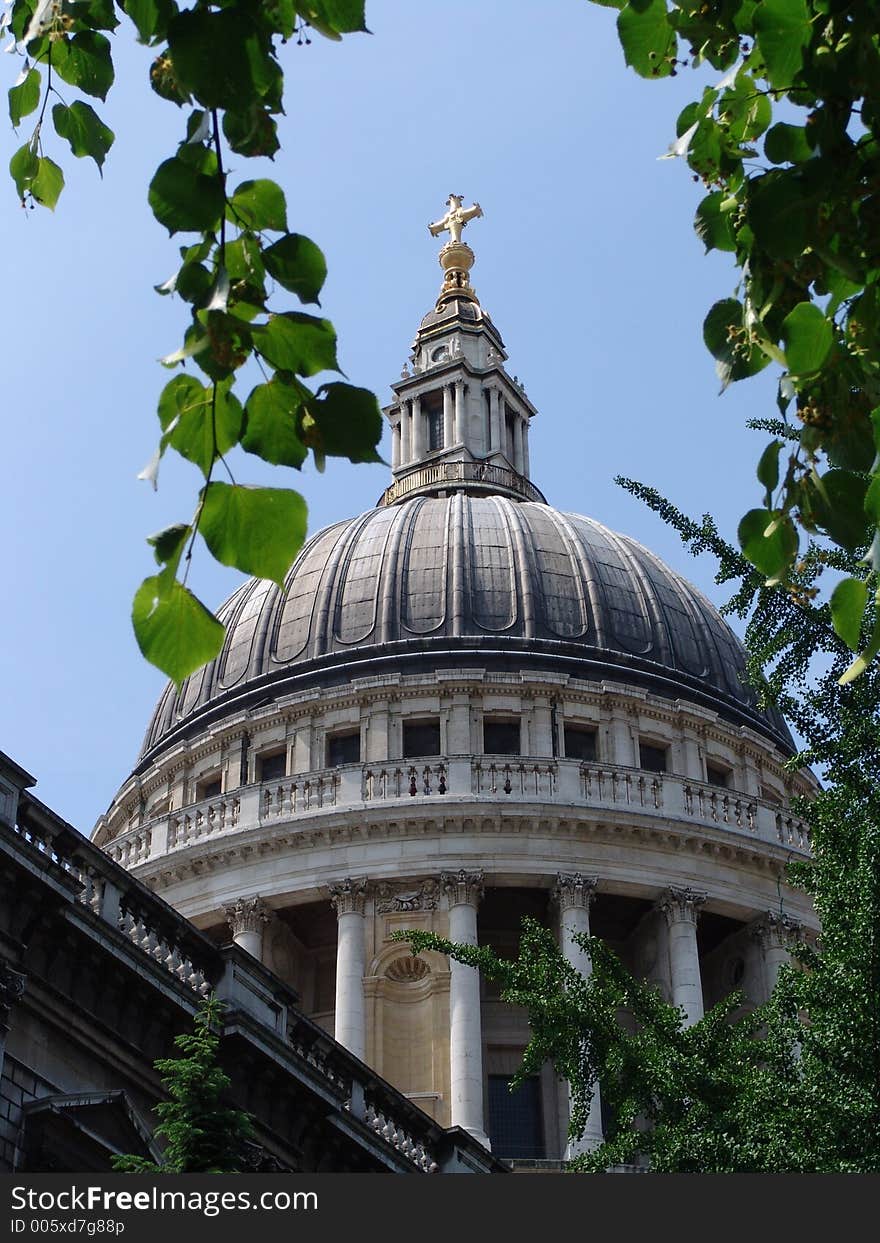 Saint Paul's Cathedral dome viewed through tree branches in the City of London