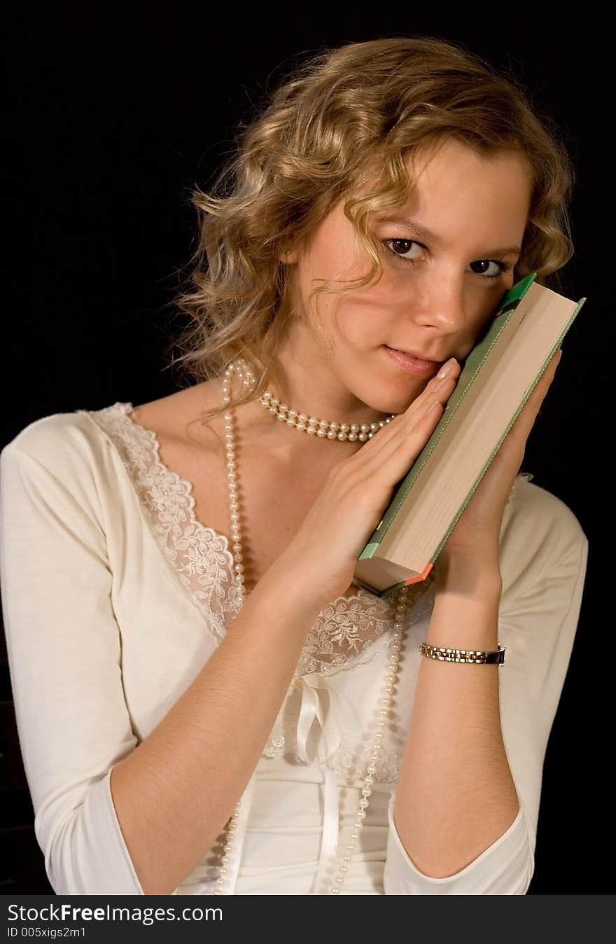 A girl holding a book. A girl holding a book