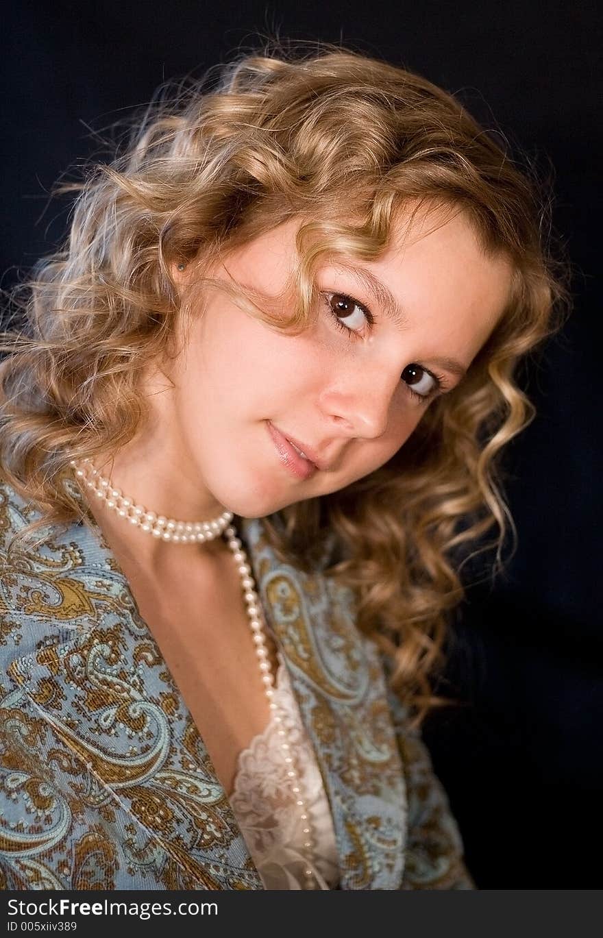 A portrait of a blondie girl over black background. A portrait of a blondie girl over black background