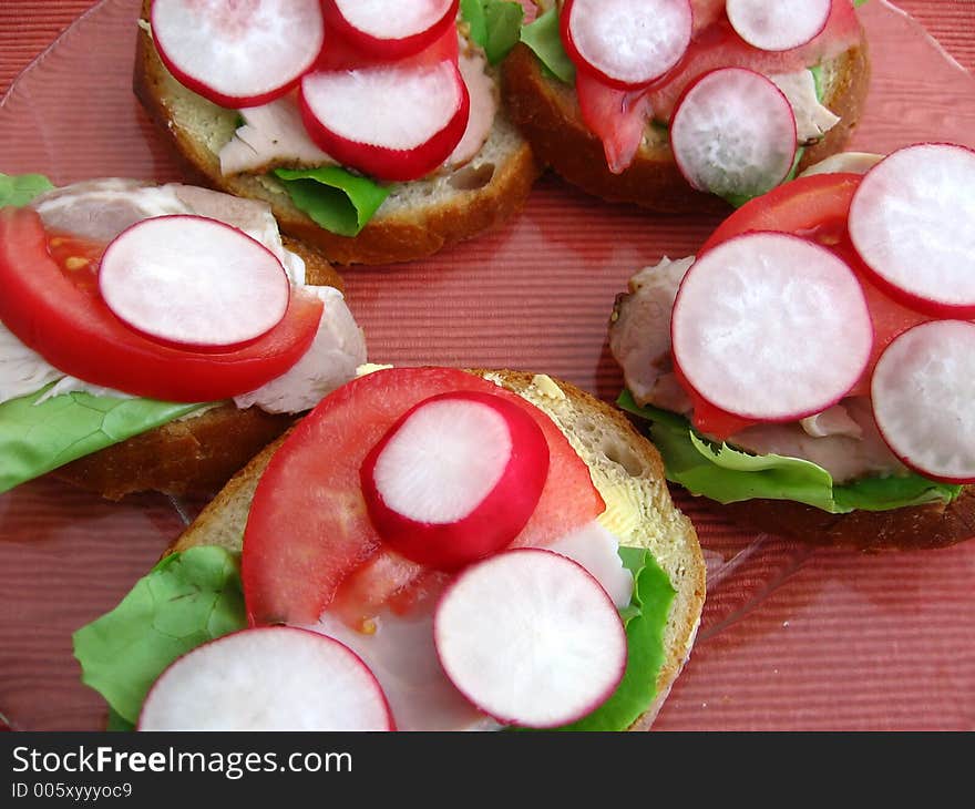 Fresh spring time sandwiches:

bread, butter, lettuce, pork, tomato, radish