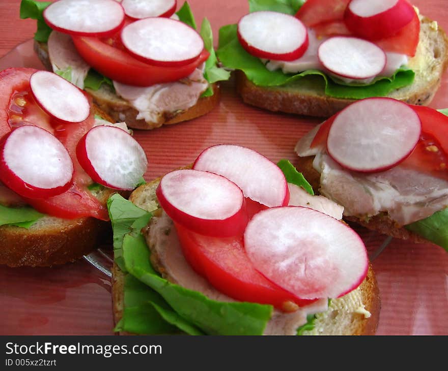 Fresh spring time sandwiches:

bread, butter, lettuce, pork, tomato, radish