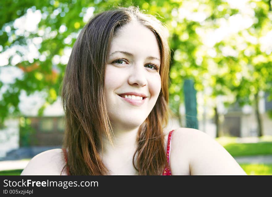 Woman in park smiling. Woman in park smiling