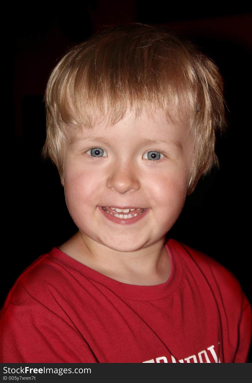 Happy boy on black background