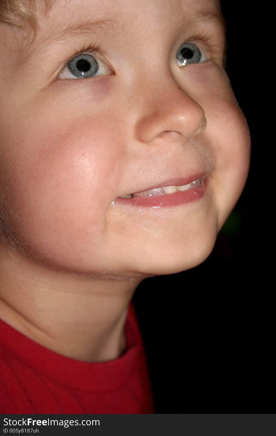 Happy boy on black background