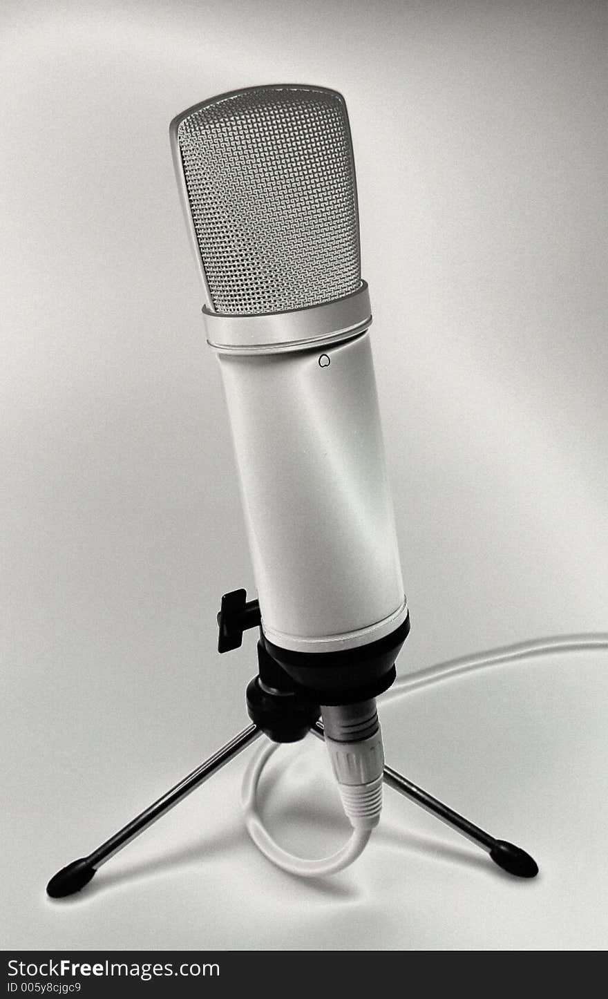 Digital solarized image of a microphone, some added film grain. Digital solarized image of a microphone, some added film grain.