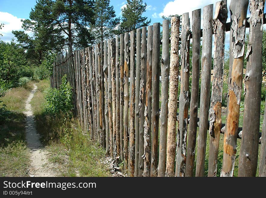 Pinewood fence along the path