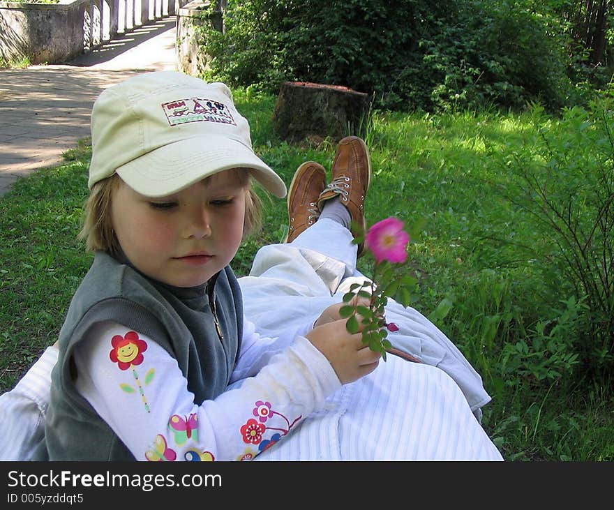 A girl resting upon father's legs. A girl resting upon father's legs