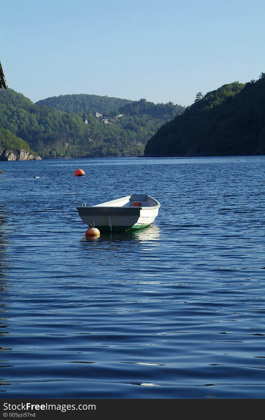 Traditional dinghy and old boathouse in a fjord on the Norwegian south coast