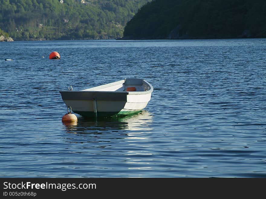 Dinghy on the water during sunset in a Norwegian fjord