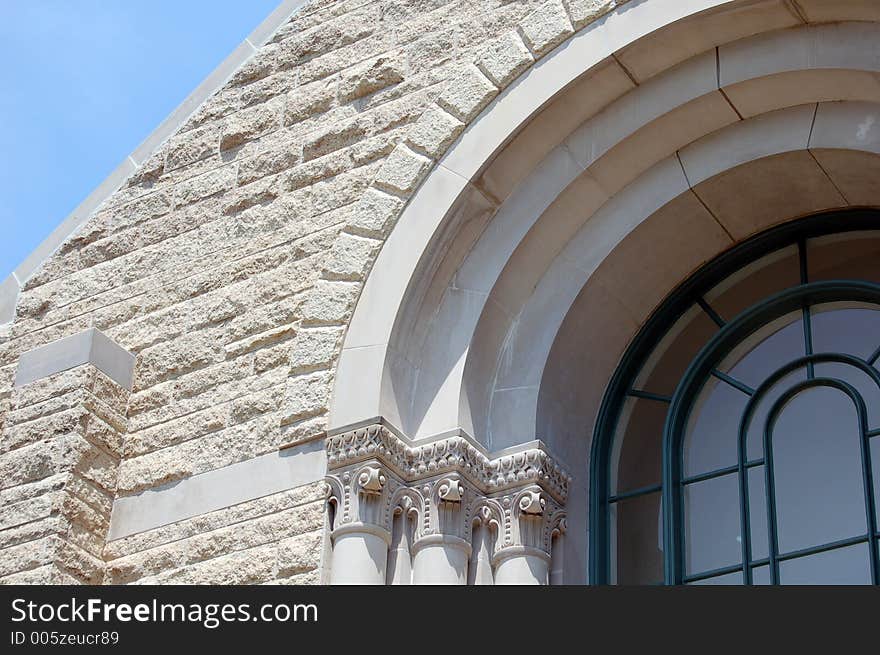 Close-up of church archway with ornate trim on outside of building. Close-up of church archway with ornate trim on outside of building.