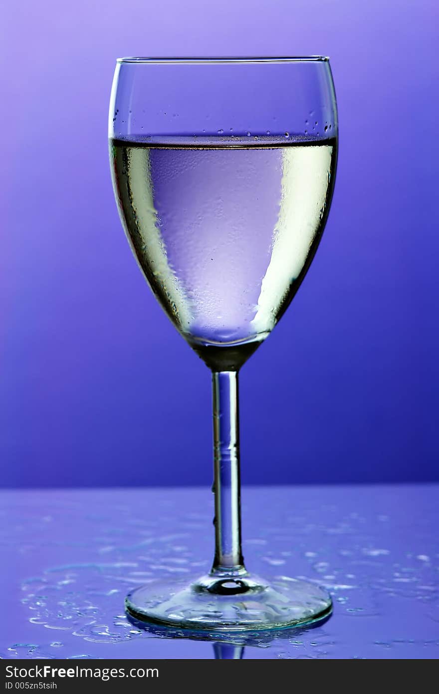 Glass of wine on blue background