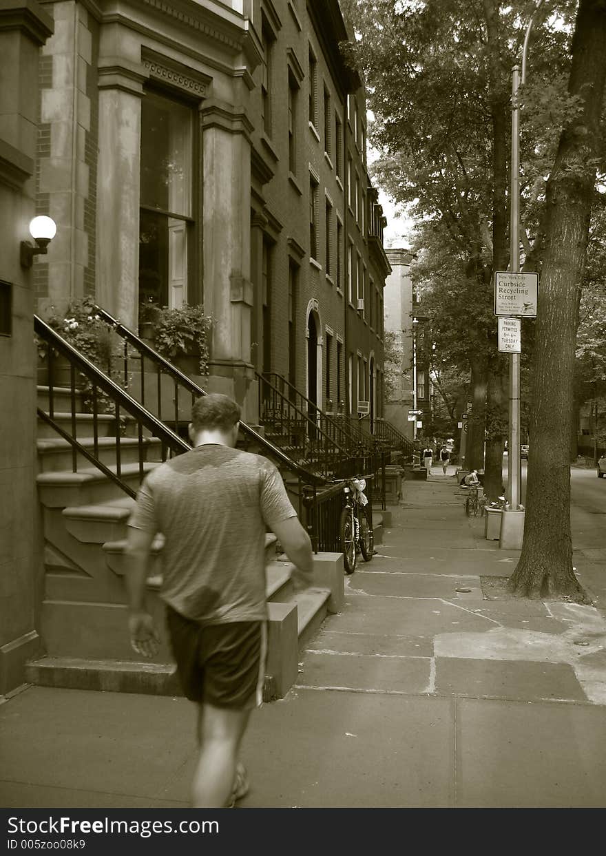 Man walking in historic brooklyn in sepia tone