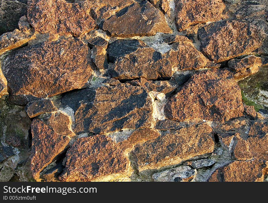 Natural stone wall at the sunset