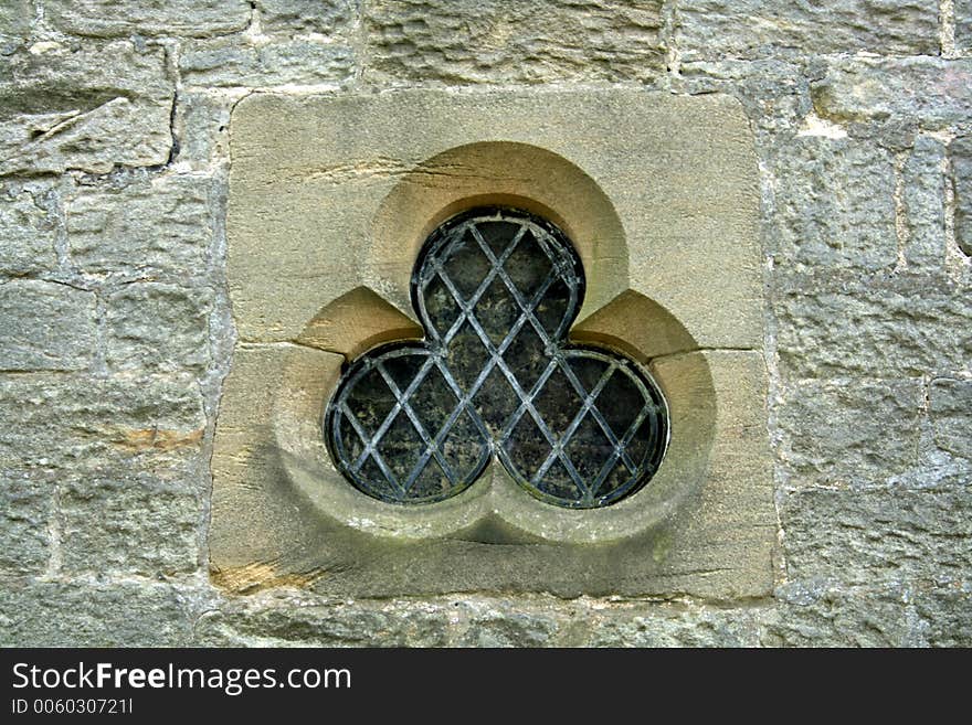 Club shpaed church window is an unusual shape with it lead cross glass