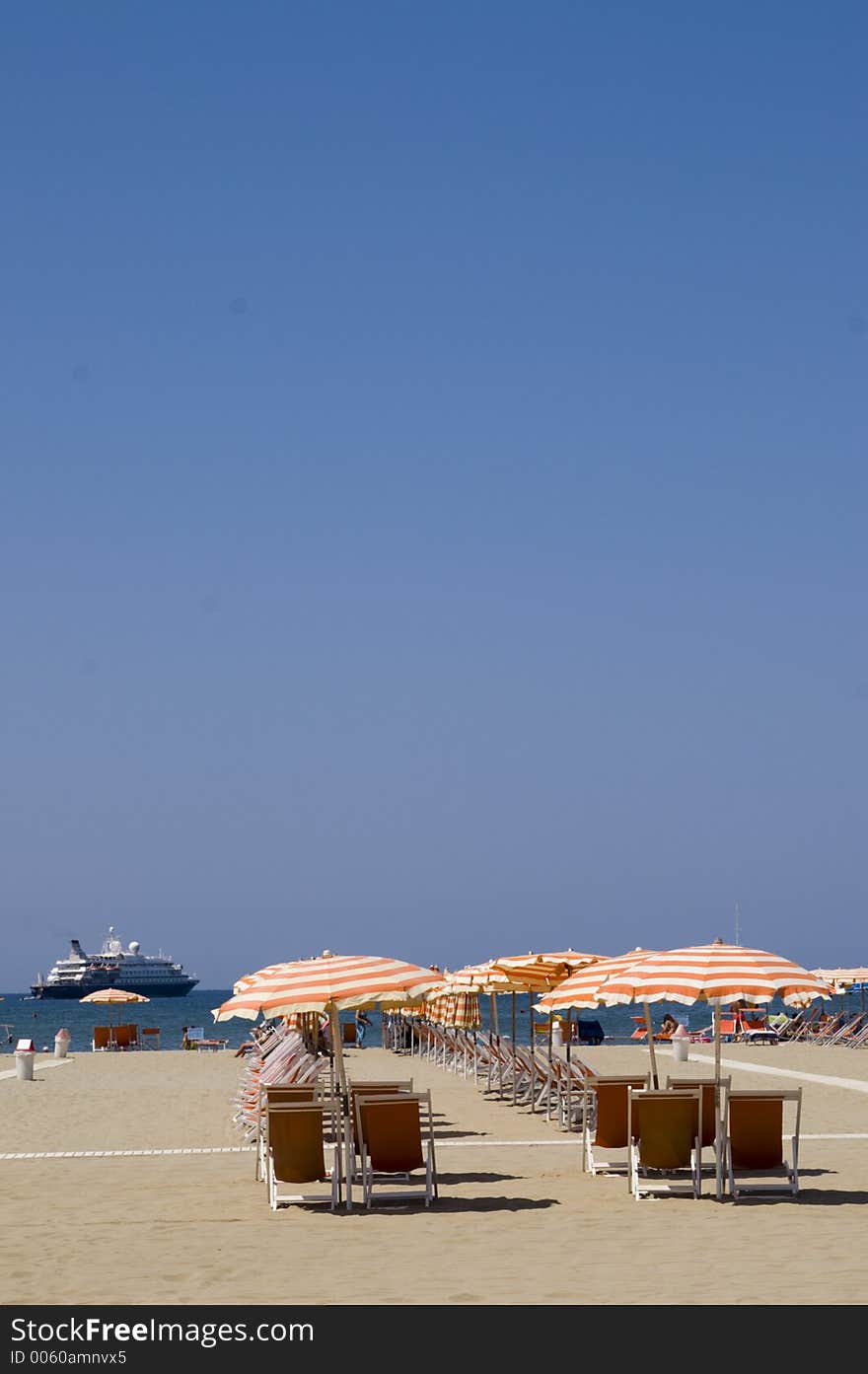 A beach in Italy with a big yacht in the background. A beach in Italy with a big yacht in the background