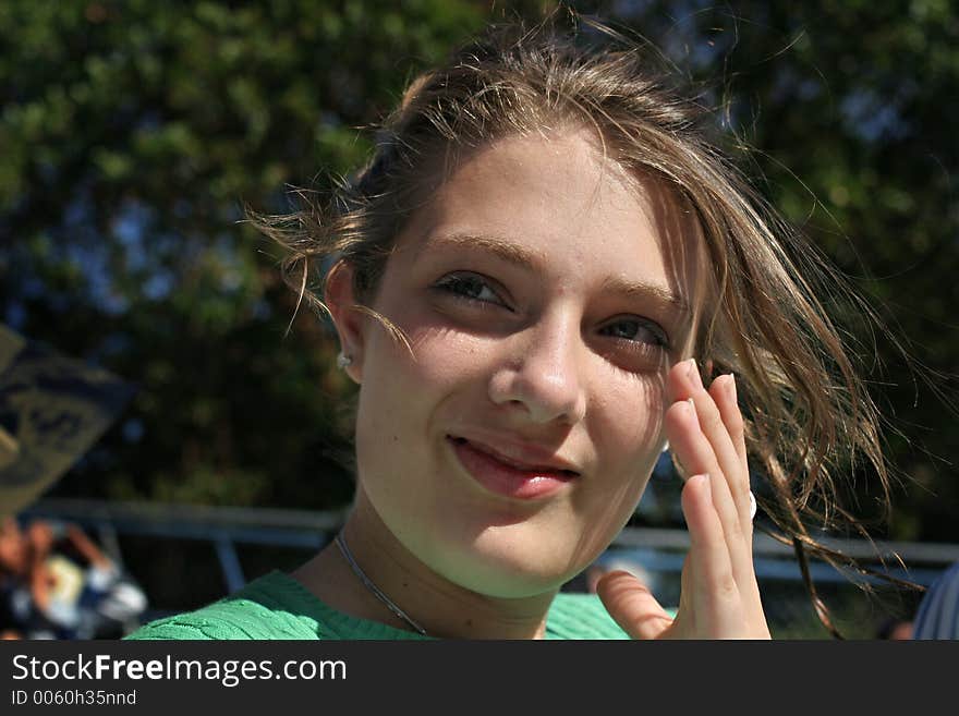 Teenage girl brushes hair off her face. Teenage girl brushes hair off her face