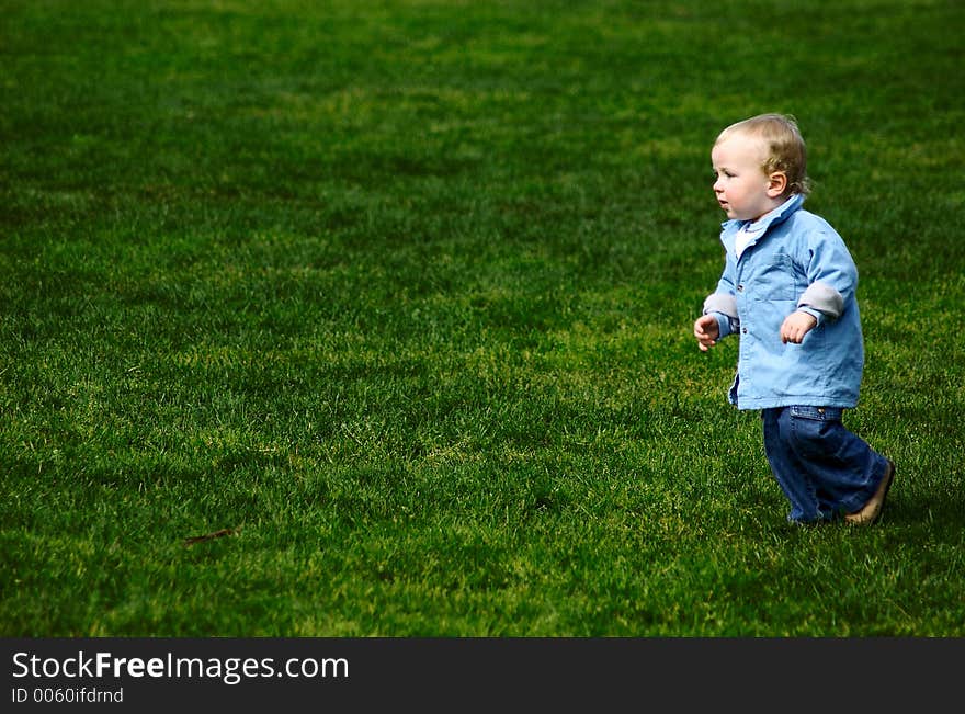 Toddler Running On Green Grass