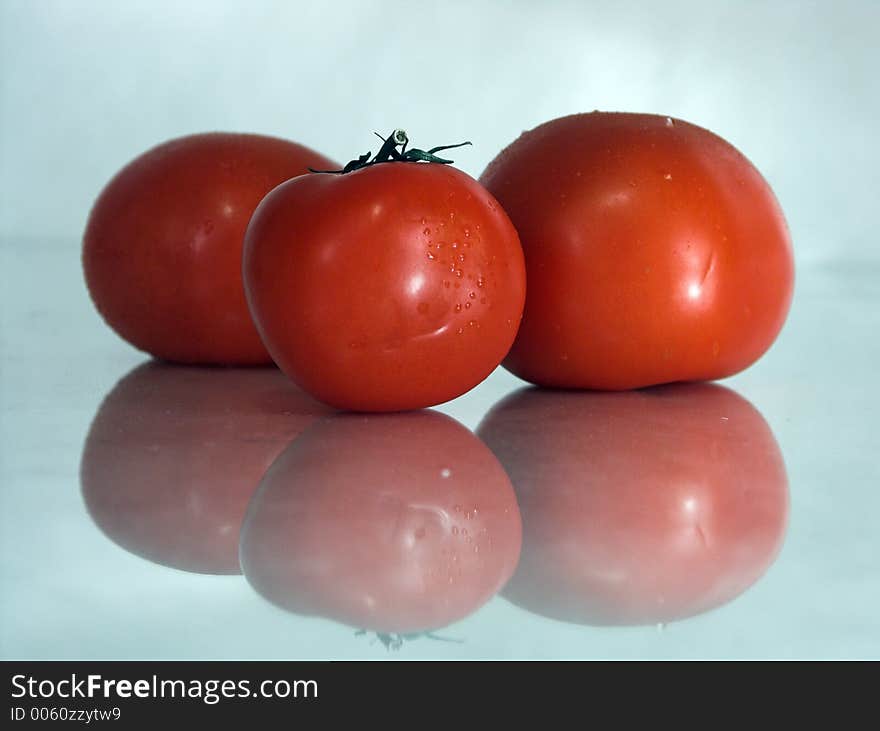 Three wet tomatoes. Three wet tomatoes