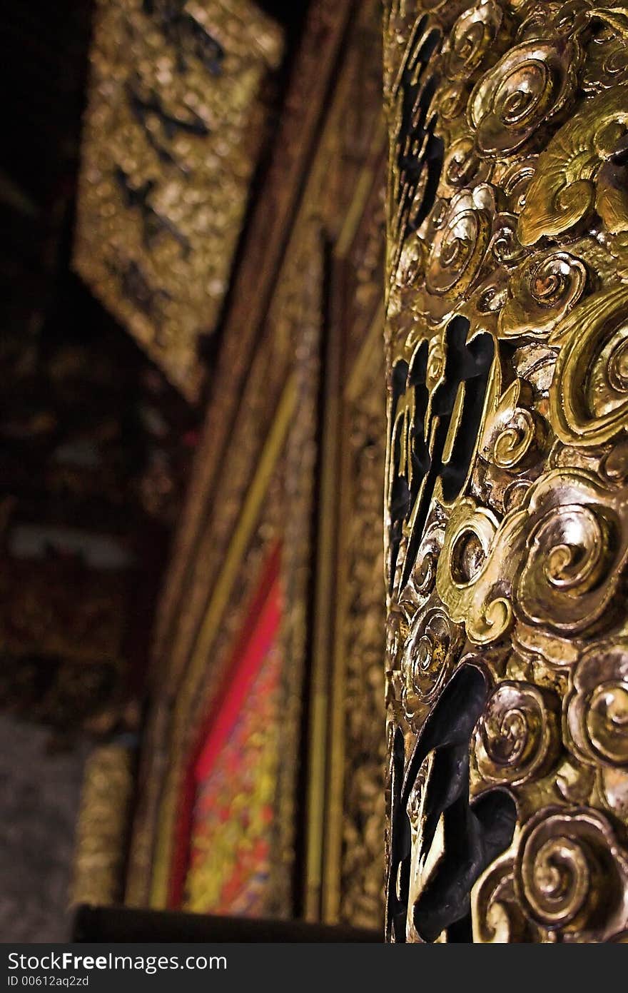 Elaborate gold pillar in a Chinese Temple with Chinese writing in background. Elaborate gold pillar in a Chinese Temple with Chinese writing in background