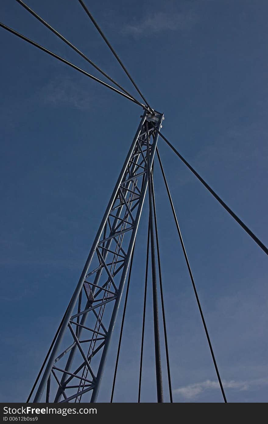 Abstract of steel suspension bridge support cables and pylon in front of blue sky