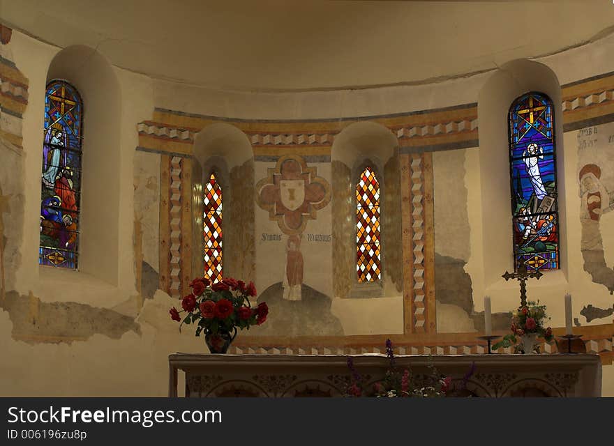 Stained glass behind a church altar in Southern France