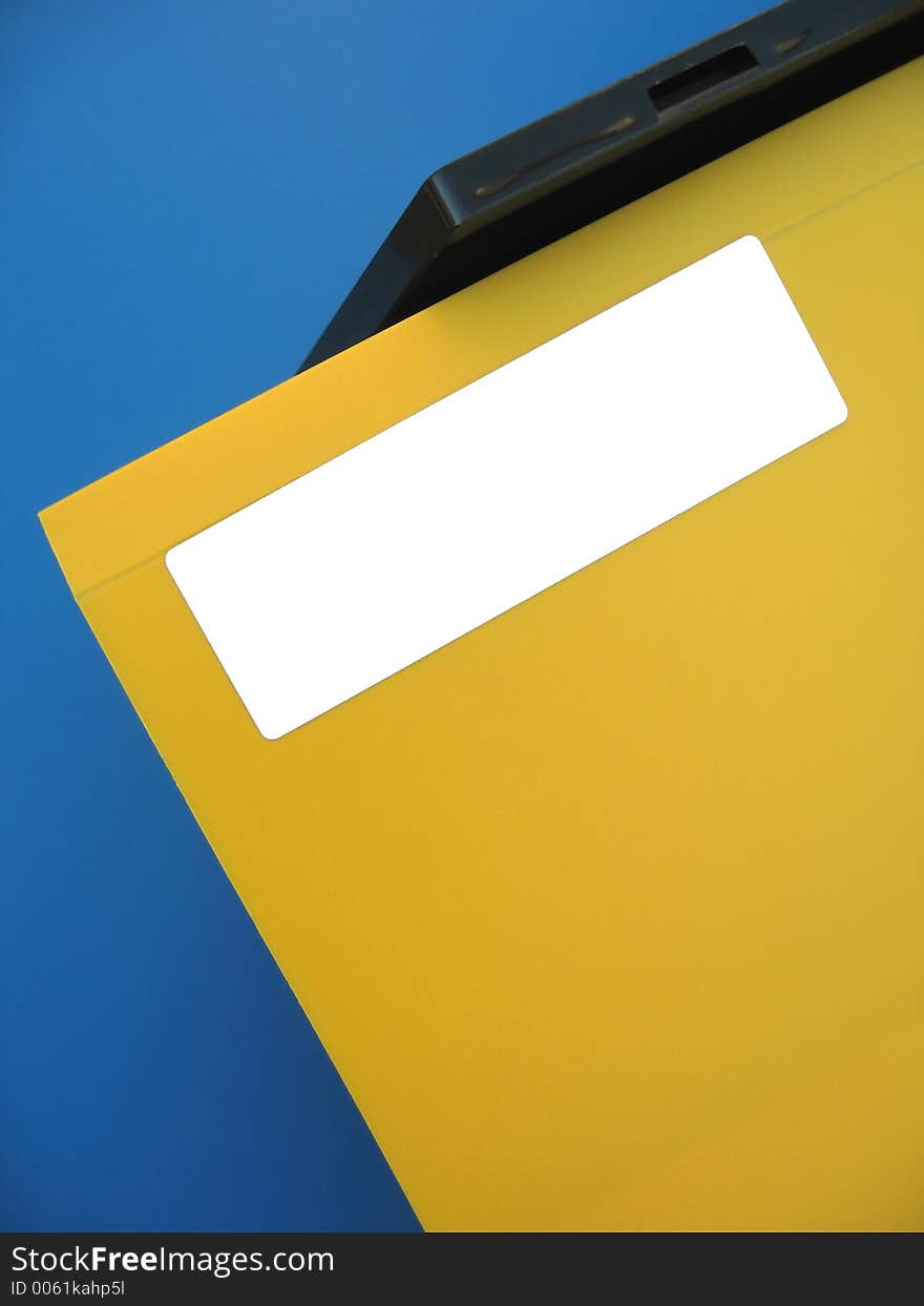 A yellow folder sitting on an office tray. Add your own word on the white label. A yellow folder sitting on an office tray. Add your own word on the white label.