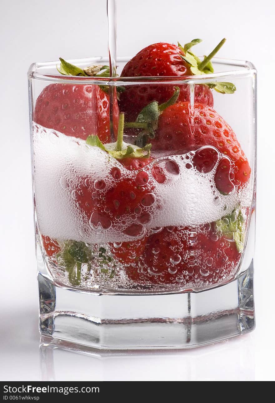 Fizzy strawberries in a glass