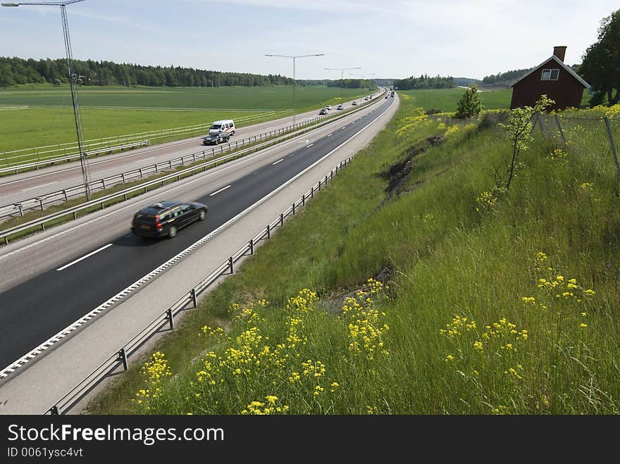 Highway in the countryside surrounded by fields and flowers. Highway in the countryside surrounded by fields and flowers