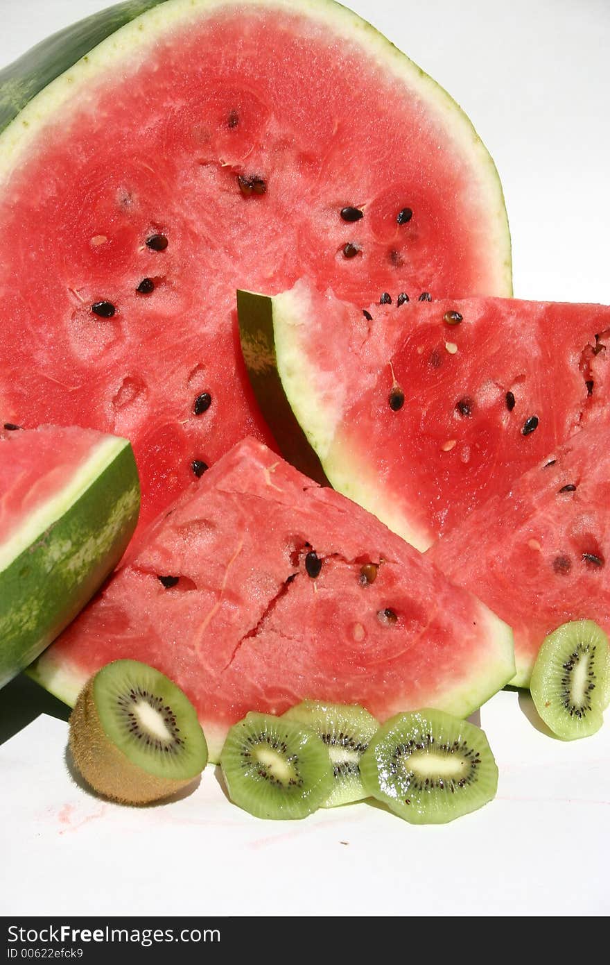 Juicy ripe watermelong and Kiwi slices on a white background. Juicy ripe watermelong and Kiwi slices on a white background.