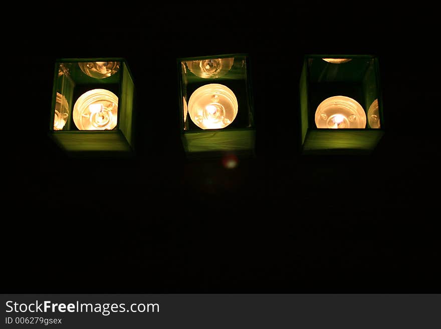 Three tealight candles in home-made glass candle holders. Three tealight candles in home-made glass candle holders