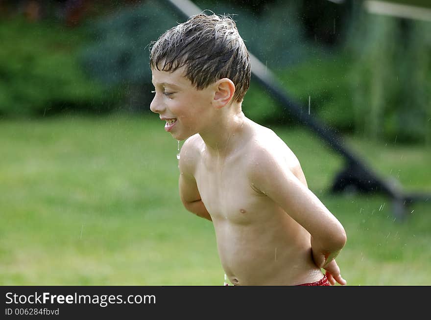 Child Playing in Sprinkler. Child Playing in Sprinkler