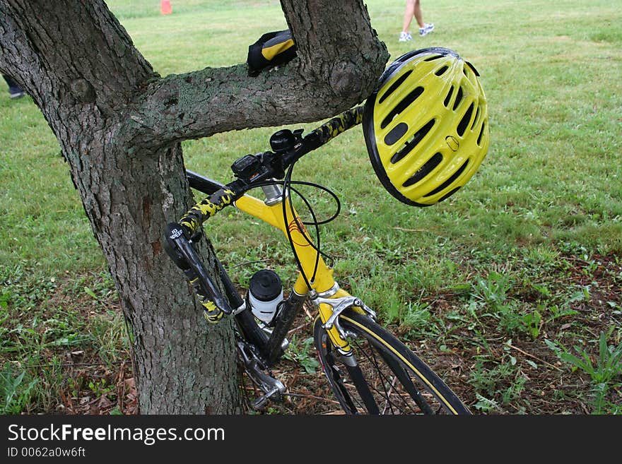 A bike rider leaves his equipment along a tree when he takes a break. A bike rider leaves his equipment along a tree when he takes a break