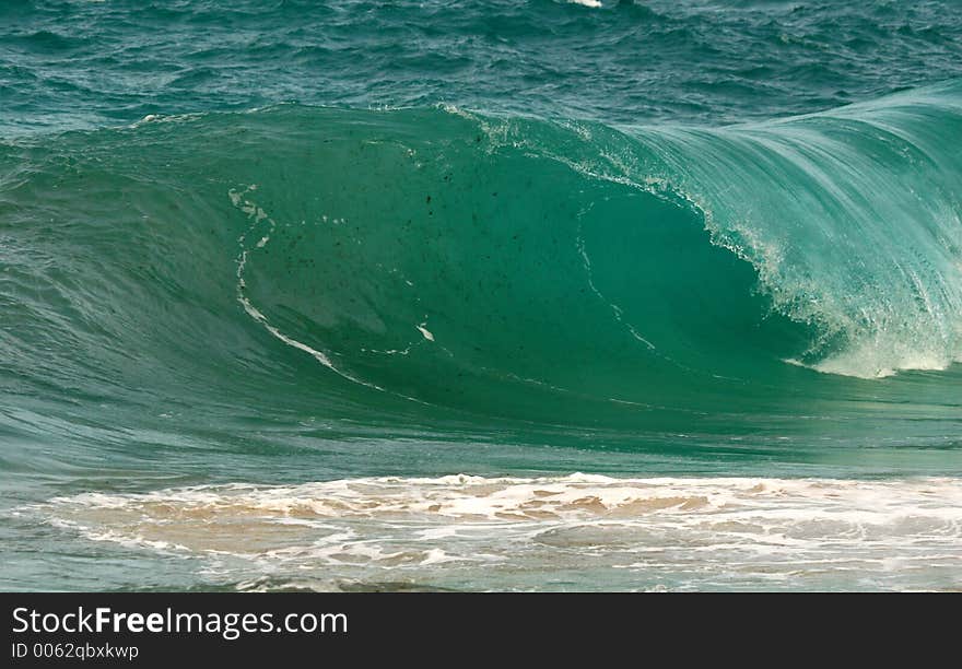 Heavy wave crashes in the shorebreak. Heavy wave crashes in the shorebreak.