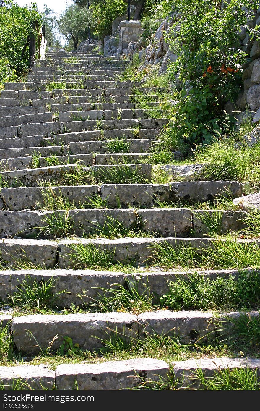 Weathered old stone steps sprouting grass. Weathered old stone steps sprouting grass