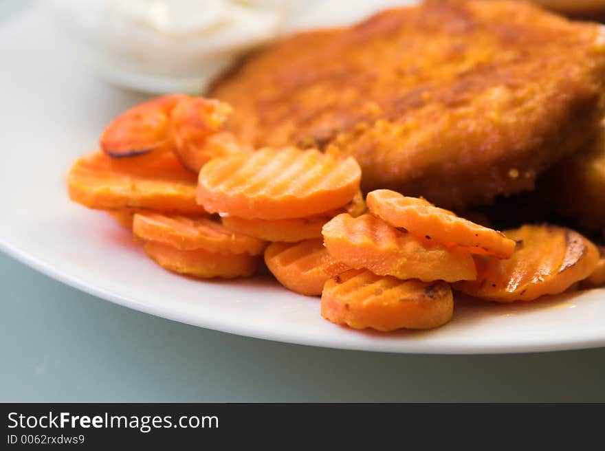 Carrot slices close-up with pieces of fried soy meat substitute. Carrot slices close-up with pieces of fried soy meat substitute