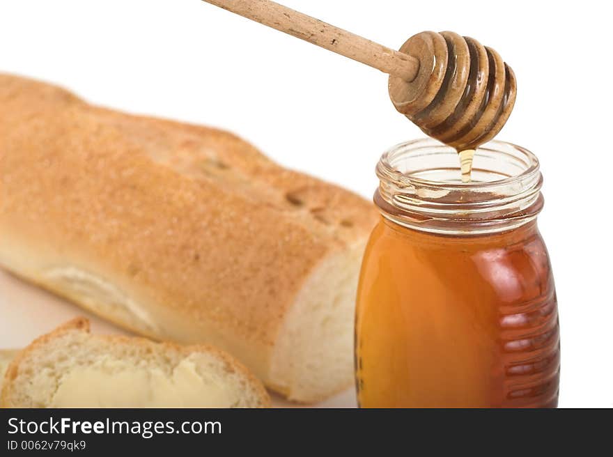 Baguette bread and honey jar. Baguette bread and honey jar