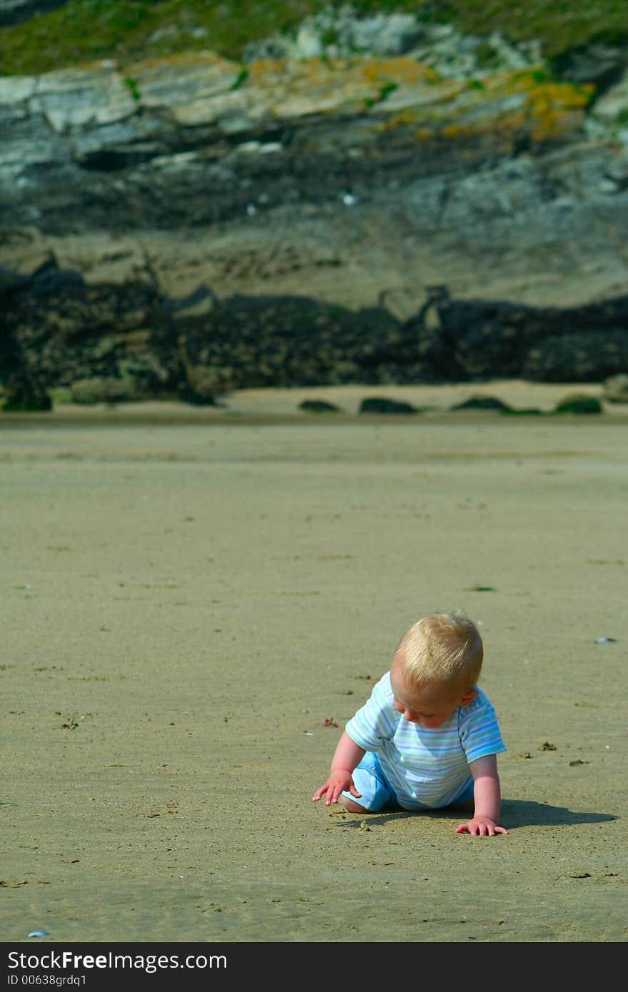 Small child exploring a beach in Cornwall. Small child exploring a beach in Cornwall.